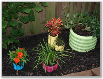 Photograph of fun colored plant pots in a yard